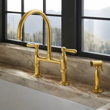 brass kitchen faucet with pull down spray on marble countertop
