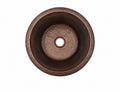 Round hammered antique copper bar sink, top view showing the dark antique patina and 3.5 inch drain opening