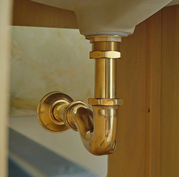 unlacquered brass p trap under bathroom sink with flange